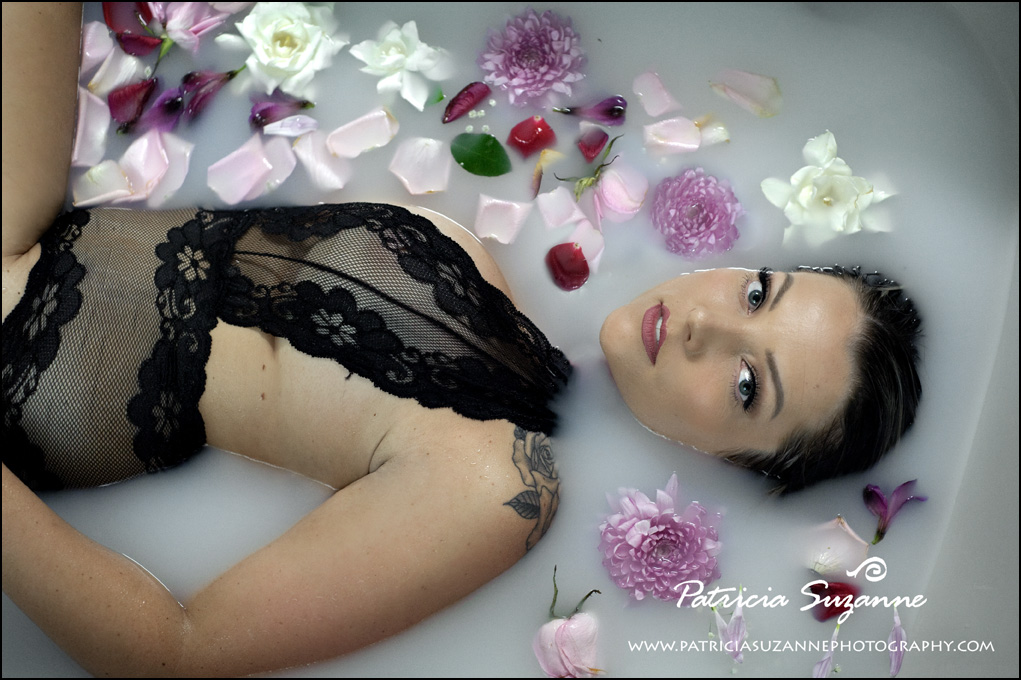 Face in milk bath boudoir surrounded by flowers